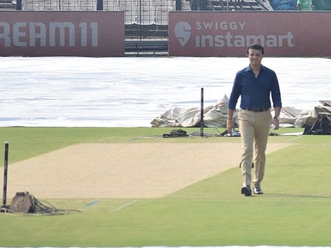 Sourav Ganguly, president of BCCI, does a recce of the wicket after a spell of rain at the Eden Gardens.