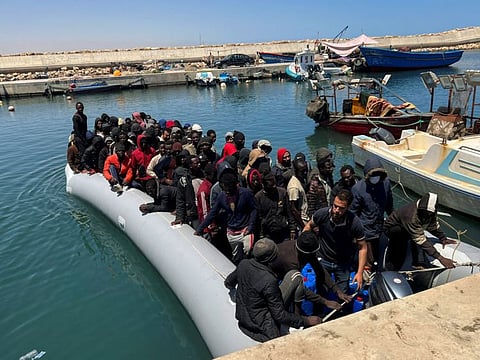 Migrants rescued by the Libyan Coast Guards in the Mediterranean Sea arrive in Garaboli, Libya, on May 23, 2022.