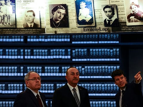 Turkish Foreign Minister Mevlut Cavusoglu visits the Hall of Names, commemorating the six million Jews killed by the Nazis in the Holocaust, at the Yad Vashem World Holocaust Remembrance Centre in Jerusalem, on May 25, 2022.