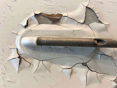 An undated image shows what appears to be paint peeling, cracking and exposed expanded copper foil (ECF) on the fuselage of a Qatar Airways A350 aircraft.