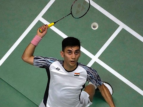 India's Lakshya Sen returns a shot to Indonesia's Anthony Ginting during their Thomas Cup final in Bangkok.