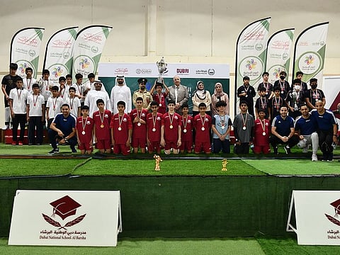 Participants of the Dubai Police-hosted Futsal Championship line up with officials.