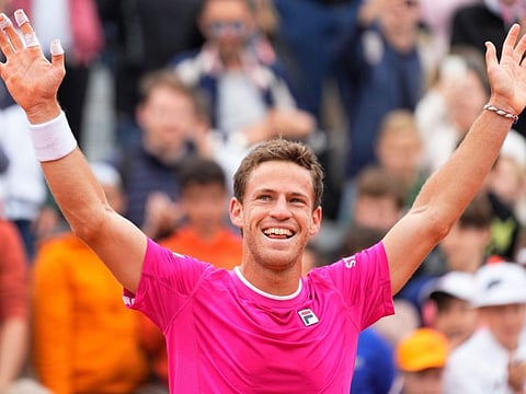 Argentina's Diego Schwartzman celebrates after defeating Bulgaria's Grigor Dimitrov during their third round match of the French Open at Roland Garros in Paris on Friday. Schwartzman won 6-3, 6-1, 6-2.