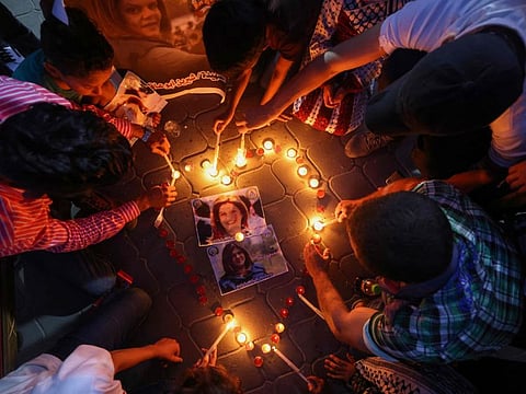 Gazans light candles during a vigil in honour of slain Palestinian Al Jazeera journalist Shireen Abu Aqleh in Gaza City on May 26, 2022.