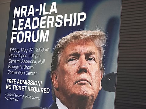 A sign showing former U.S. President Donald Trump, who will be speaking at the NRA-ILA Leadership Forum, stands posted inside the National Rifle Association (NRA) annual convention at the George R. Brown Convention Center in Houston, Texas, U.S., May 26, 2022.