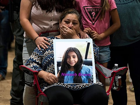 Esmeralda Bravo, 63, sheds tears while holding a photo of her granddaughter, Nevaeh, one of the Robb Elementary School shooting victims, during a prayer vigil in Uvalde, Texas, Wednesday, May 25, 2022.