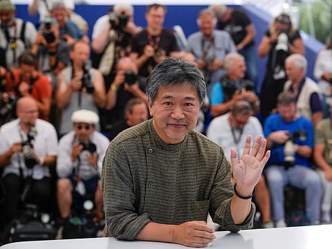 Director Hirokazu Kore-eda poses for photographers at the photo call for the film 'Broker' at the 75th international film festival, Cannes, southern France, Friday, May 27, 2022.