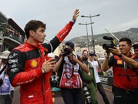 Ferrari's Charles Leclerc celebrates after qualifying in pole position for the F1 Monaco Grand Prix on Sunday.