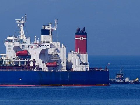 The Pegas tanker, that has recently changed its name to Lana, the blue one foreground, is seen off the port of Karystos on the Aegean Sea island of Evia, Greece, Friday, May 27, 2022. The crude oil cargo of the Iranian-flagged tanker that was stopped in Greek waters last month has been seized and is being transferred to another vessel following a request from the US, a Greek official said.