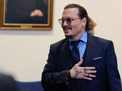 Actor Johnny Depp gestures to spectators in court after closing arguments during his defamation case against ex-wife Amber Heard at the Fairfax County Circuit Courthouse in Fairfax, Virginia.