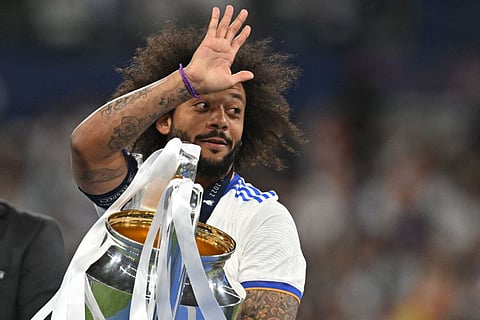 Real Madrid's Marcelo celebrates with the Champions League trophy. The defender says he is leaving the club after 16 years.