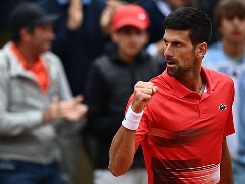 Serbia's Novak Djokovic reacts after winning against Diego Schwartzman during their men's singles match on day eight of the Roland-Garros Open tennis tournament at the Court Suzanne-Lenglen in Paris.