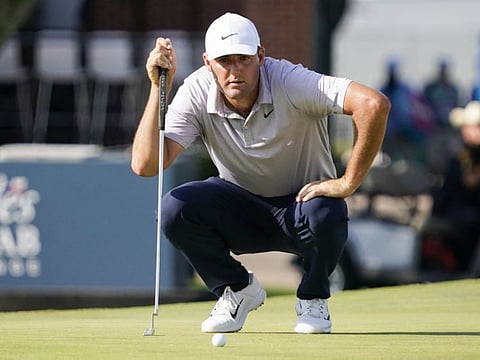 Scottie Scheffler lines up a putt on the 18th green during the third round of the Charles Schwab Challenge golf tournament at Fort Worth, Texas.