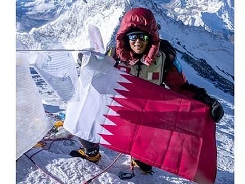 Sheikha Asma raising the Qatari flag on top of the highest mountain peak on earth, at a height of 8,849m. She is also attempting to become the first woman from the Middle East to complete the Explorers Grand Slam, which involves climbing all Seven Summits.