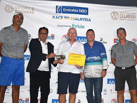 Winner of Division 1 of the Jumeirah Golf Estates Qualifying Round for the 2022 Emirates NBD Race to Malaysia, Alan McNamara, with officials and sponsors at the prize presentation.