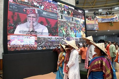 Farmers virtually watch Prime Minister Narendra Modi addressing ‘Garib Kalyan Sammelan’, at Railway Indoor Stadium, in Kolkata on Tuesday.