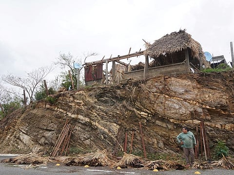 A man stands near a restaurant damaged in the aftermath of Hurricane Agatha, in San Isidro del Palmar, Oaxaca state, Mexico, May 31, 2022.