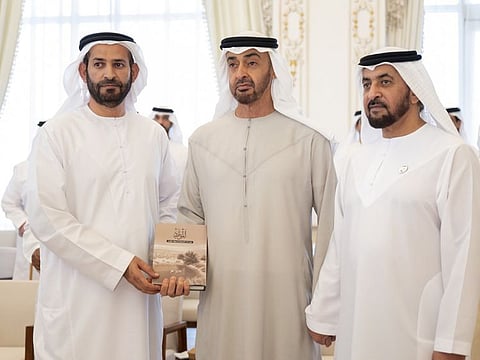 Sheikh Mohamed with his copy of 'Resources', a book by Emirati author and researcher Ali Ahmed Al Kindi.
