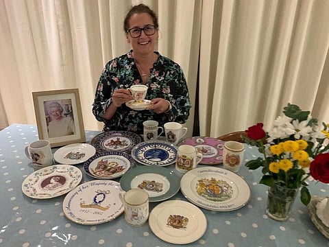 Abigail Fishbourne with commemorative plates released to mark events and milestones in the royal family.