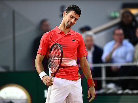Serbia's Novak Djokovic reacts after losing against Spain's Rafael Nadal during their men's singles match on day ten of the Roland-Garros Open tennis tournament at the Court Philippe-Chatrier in Paris.