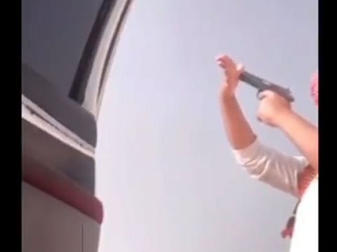 The man appears in a clip in a desert area where he points a gun at his right hand, and fires, leading to bleeding in the aftermath.