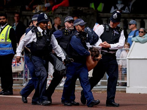 Police officers detain a protester who tried to disrupt the ceremony during the Queen's Platinum Jubilee celebrations on The Mall, in London, on June 2, 2022.