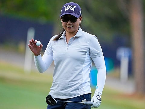 Early leader Mina Harigae of the US reacts to saving par on the 18th green during the first round of the US Women's Open golf tournament on Thursday.