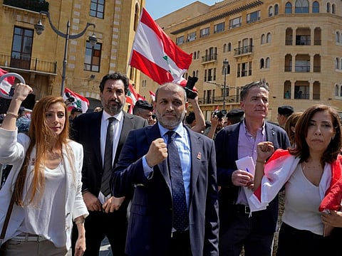 Newly elected independent members of parliament from the 2019 protest movement raise their fists (a symbol of the 2019 protests) as they arrive to the legislature, in Beirut, on May 31, 2022.