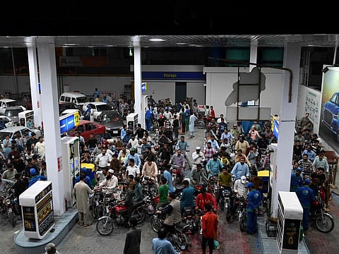 Motorists wait to fill their vehicles' tanks at a petrol station in Islamabad on June 2, 2022.