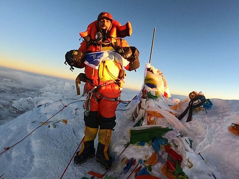 This handout photograph taken on May 27, 2022 and released on June 3, 2022 by the Pioneer Adventure Pvt. Ltd shows Indian mountaineer Narender Singh Yadav posing at the summit of Mount Everest.