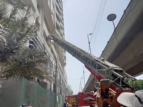 Firefighters at the scene of fire in Karachi.