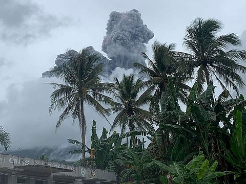 Ash and steam are spewed from Mount Bulusan.