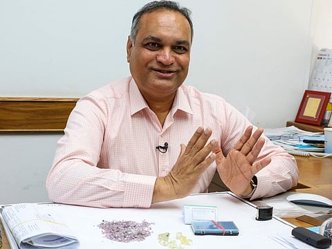 Pravin Kukadia, Director of Eminent Gems LTD, speaks during an interview with AFP at his office in the Israel World Diamond Centre in the city of Ramat Gan city on the outskirts of Tel Aviv on May 16, 2022.