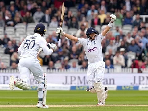 Joe Root (right) celebrates as England win by five wickets on the fourth day of the first Test against New Zealand at Lord's in London.