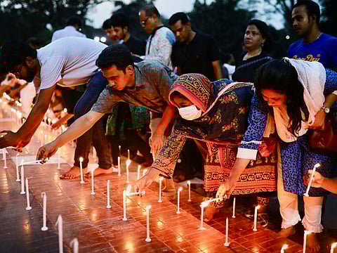 Members of Sommilito Sangskritik Jote organisation participate in a candlelight vigil in remembrance of the victims of the fire that broke out in an inland container depot in Sitakunda, in Dhaka, Bangladesh, June 6, 2022.