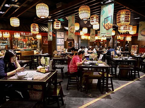 People dine at a restaurant in Beijing on June 6, 2022, after the government eased some Covid-19 restrictions with most dine-in services resuming in the city.