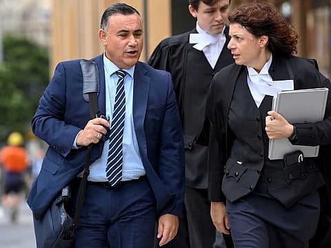 Former New South Wales Deputy Premier John Barilaro, left, arrives at the The Federal Court of Australia in Sydney on March 23, 2022.