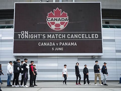 Fans gather outside B.C. Place stadium after the Canadian national men’s soccer team’s match against Panama was canceled in Vancouver, British Columbia.
