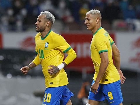 Brazil's Neymar (left) celebrates after scoring a penalty with Richarlison.