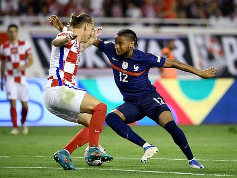 France's midfielder Christopher Nkunku (right) fights for the ball with Croatia's defender Domagoj Vida during the UEFA Nations League - League A Group 1 match at Stadion Poljud in Split.