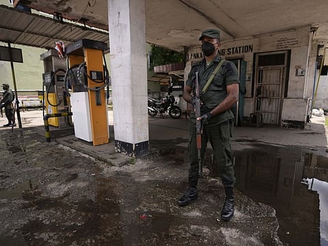 Sri Lankan soldiers secure a deserted fuel station in Colombo. The country is facing its worst economic crisis in recent memory.