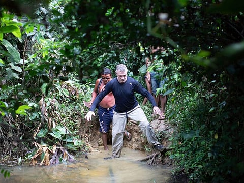 British journalist Dom Phillips, right, and a Yanomami Indigenous man walk in Maloca Papiu village, Roraima state, Brazil, Nov. 2019. Phillips and Indigenous affairs expert Bruno Araujo Pereira have been reported missing in a remote part of Brazil's Amazon region, a local Indigenous association said on June 6, 2022.