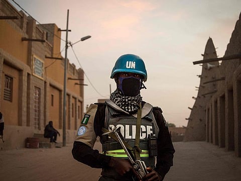 In this file photo taken on December 09, 2021 policemen of the United Nations Stabilisation Mission in Mali (MINUSMA), patrol in front on the Great Mosque in Timbuktu.