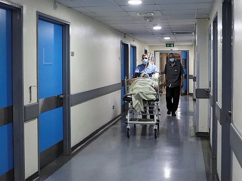 A healthcare worker wheels a patient inside a hospital in Beirut, Lebanon.
