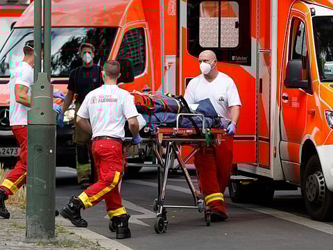 An injured person is transported off the site where one person was killed when a car drove into a group of people in central Berlin, on June 8, 2022.