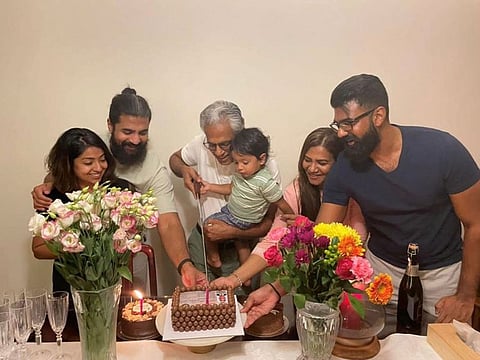 Esmail Pillai Salim's family joins him in cutting a cake carrying the image of his licence that shows his date of birth, the date of issue of his first licence and the date of expiry of the last renewed license on May 30, 2022.