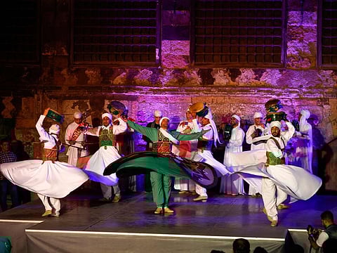 A troupe of whirling dervishes performs the traditional "tanoura" (skirt) dance during Ramadan, at the medieval Sultan al-Ghuri Complex (built in 1505) in the Islamic Cairo district of Egypt's capital on April 20, 2022.