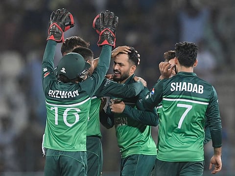 Pakistan's Mohammad Nawaz (right) celebrates with teammates after taking the wicket of West Indies' Rovman Powell (not pictured) during the second one-day international (ODI) cricket match at the Multan Cricket Stadium in Multan.