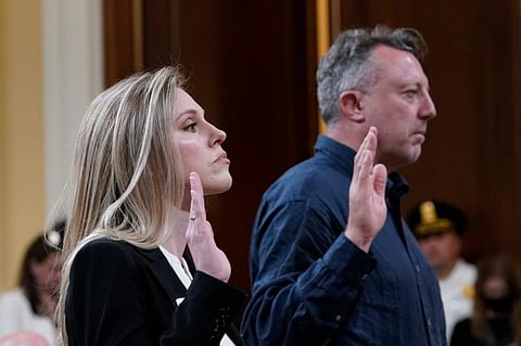 US Capitol Police officer Caroline Edwards, left, and British filmmaker Nick Quested, are sworn in as the House select committee investigating the Jan. 6 attack on the U.S. Capitol holds its first public hearing to reveal the findings of a year-long investigation, on Capitol Hill in Washington, Thursday, June 9, 2022.