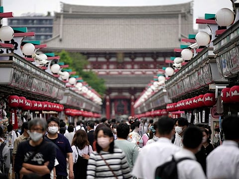 Visitors walk along a shopping street at the Asakusa district Friday, June 10, 2022, in Tokyo.